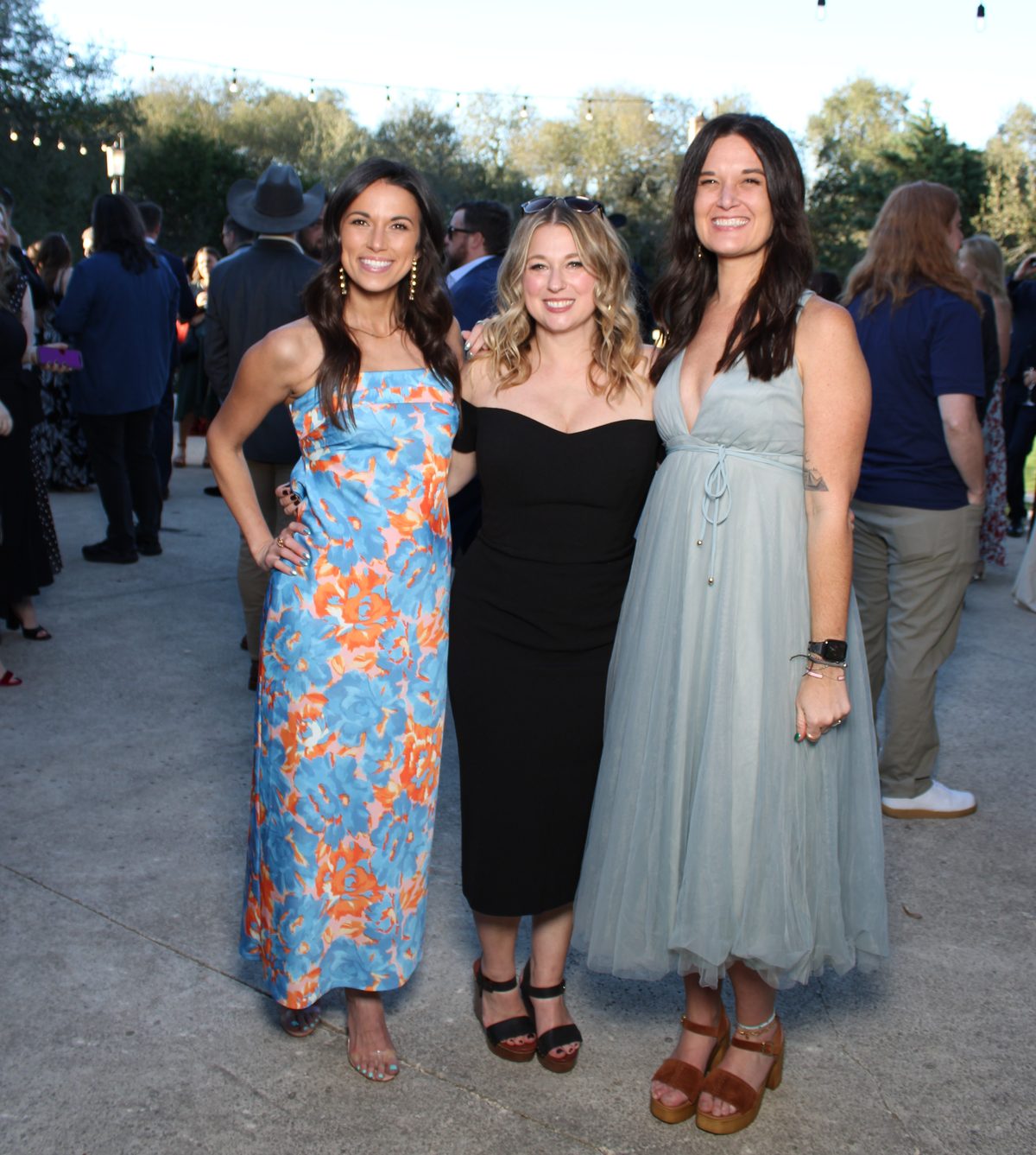Three friends posing at an outdoor Austin wedding